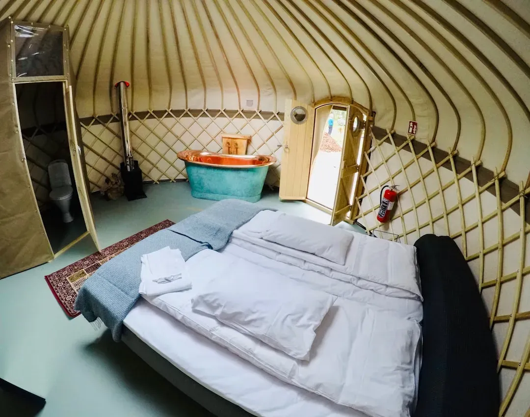 cozy yurt interior with a bed and a window, perfect for a stopover
